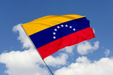 Venezuela flag isolated on the blue sky background. close up waving flag of Venezuela. flag symbols of Venezuela. Concept of Venezuela.