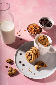 Fresh chocolate ship cookies making splash in a cup of milk