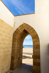 arch in the wall is the entrance to the beach in Rota in Andalusia