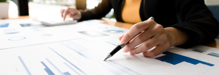 Close up of accountant or banker checking investment results, calculates financial savings, calculates annual taxes and economic concepts. Financial calculation concept.