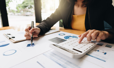 Fototapeta premium Close up view of bookkeeper or financial inspector hands making report, calculating or checking balance. Home finances, investment, economy, saving money or insurance concept.