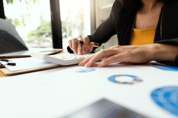 Close up of accountant or banker checking investment results, calculates financial savings,...