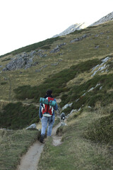 boy walking with backpack in the mountain