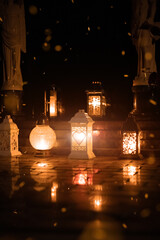 cemetery ritual light candle in lamp objects fire flame on tombstone with sparks at night darkness...
