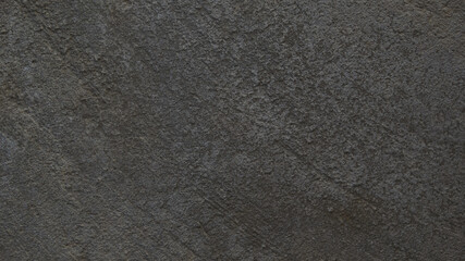 Textured gray concrete background. Old wall or floor made of dark gray cement. Scuffed and cracked. Copy space. Attrition.