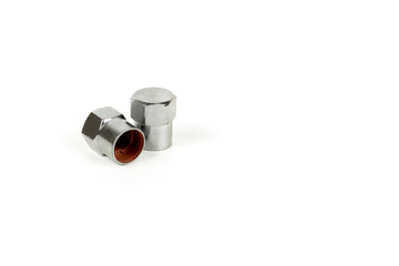 cap shiny on the valve for pumping a wheel of a car made of silver metal. copy space