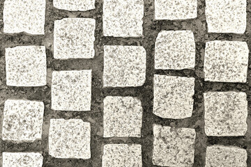 The road is paved with square stone slabs