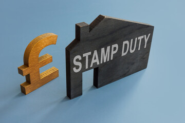 House model with inscription Stamp duty and sign of pound. - obrazy, fototapety, plakaty