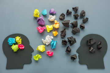 Positive and negative thinking concept. Figures of heads and paper balls.
