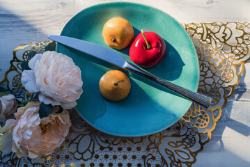 cut fake fruits on the plate