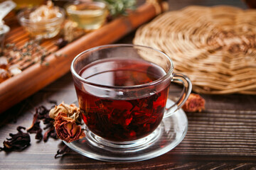 cup of herbal red tea with dry roses hibiscus