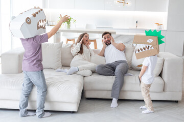 Happy family playing dinosaurs at home