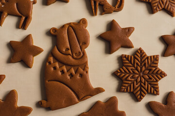 Pattern of Christmas gingerbread cookies in the form of animals, trees, snowflakes