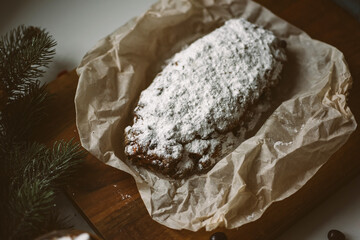 Appetizing Christmas pastries, stollen on a wooden board with Christmas decor