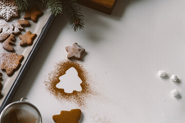 Kitchen table with gingerbread cookies and christmas decor, christmas tree