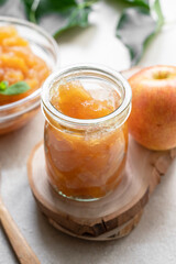 Apple jam in glass jar, delicious fruit jam, rustic style, day natural light.