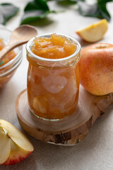 Apple jam in glass jar, delicious fruit jam, rustic style, day natural light.
