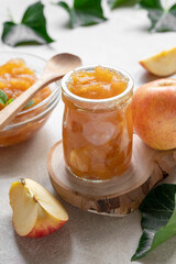 Apple jam in glass jar, delicious fruit jam, rustic style, day natural light.