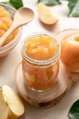Apple jam in glass jar, delicious fruit jam, rustic style, day natural light.