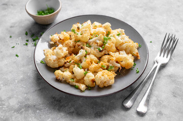 Vegetarian healthy food. Cauliflower baked with cheese, olive oil and parsley.