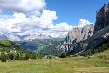 Fototapeta na wymiar Alta Badia (Dolomiti) - August: Beautiful summer mountain view of Passo Sella and high peak Sassopiatto and Sassolungo, Langkofel, Dolomiti, Sella group. 