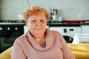 portrait of an overweight elderly woman looking at camera. problems with extra kilograms in people