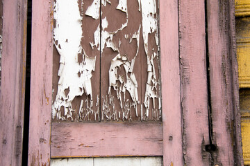 Wooden architecture of Siberia, old Windows with wooden carved architraves. old peeling paint on the wooden Windows