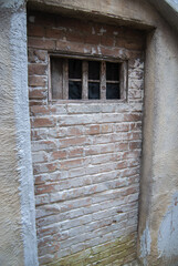 Medieval prison wall with bricks and bars. Medieval punishment