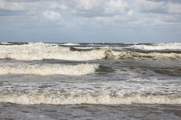 Stormy weather at the sea with clouds and waves