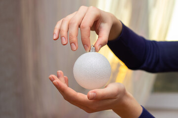 The girl is holding a Christmas tree toy, New Year's holiday and Christmas