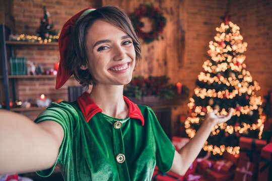 Photo of shiny charming young lady wear elf clothes recording video celebrating christmas smiling indoors house home room