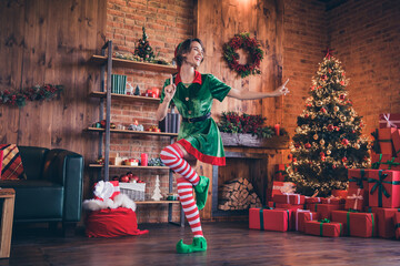 Full size photo of young positive santa helper woman christmas dance enjoy xmas indoors inside...