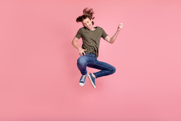 Fototapeta na wymiar Full length photo of young guy happy positive smile jump play guitar music isolated over pastel color background