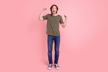 Full body photo of young guy happy positive smile rejoice victory success fists hands isolated over...