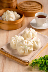 Obraz na płótnie Canvas Baozi or Bakpao is a type of yeast-leavened filled bun in various Chinese cuisines. There are many variations in fillings (meat, chocolate) and preparations, though the buns are most often steamed.