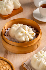 Fototapeta na wymiar Baozi or Bakpao is a type of yeast-leavened filled bun in various Chinese cuisines. There are many variations in fillings (meat, chocolate) and preparations, though the buns are most often steamed.