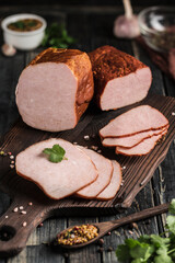 A large piece and slices of carbonade on a wooden board