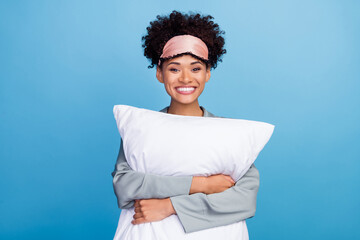 Photo of young cheerful african lady hug pillow blindfold sleepover bed isolated over blue color...