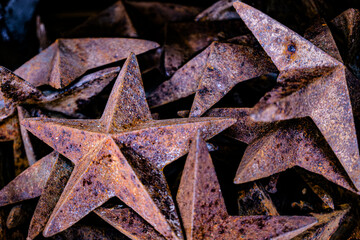 Piled rusted tin stars for home decoration, geometric shapes filling frame on horizontal frame