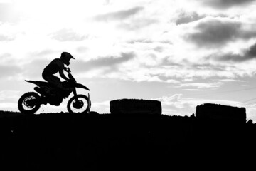 Obraz na płótnie Canvas silhouette of a person riding a motorcycle