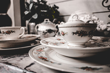 pattern fine china set on farm table in antique shop