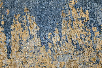 beautiful detailed texture old cracked blue paint on shabby yellow concrete wall