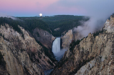 Moon set at sunrise, Lower Falls of the Yellowstone River and Grand Canyon, Yellowstone National Park, Wyoming, USA