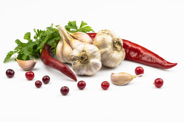 Garlic heads, hot red pepper, parsley leaves, cranberries isolated on white background.