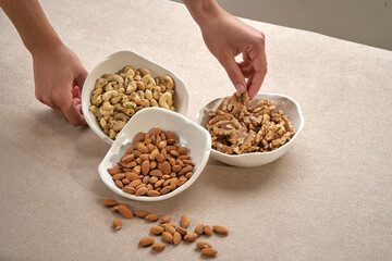 healthy snack: mixed nuts and dried fruits in handmade white ceramic bowl