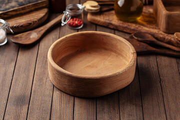 Round wooden empty bowl on the wooden rustic background