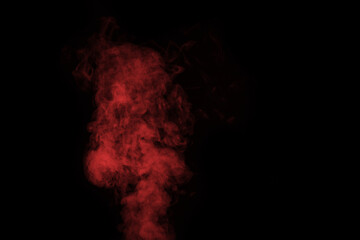Fragment of red steam smoke isolated on a black background, close-up. Create mystical Halloween photos. Abstract background, design element