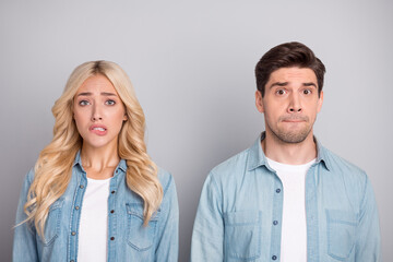 Photo of young couple worried nervous bite lips teeth fail problem anxious isolated over grey color background
