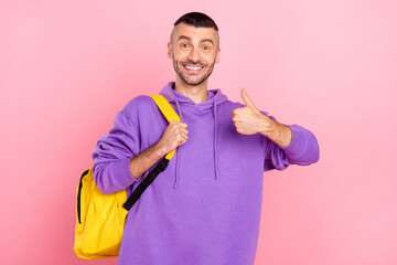 Photo of cool millennial brunet guy thumb up wear hoodie pants shoes bag isolated on pink background