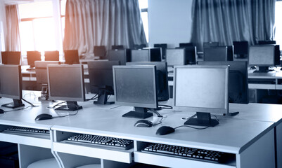 Group of computers neatly placed in a computer lab.